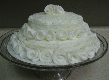 White wedding cake with buttercream frosting and fondant roses