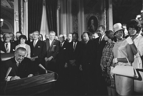 Photograph of President Lyndon Johnson Signs the Voting Rights Act as Martin Luther King, Jr., with Other Civil Rights Leaders in the Capitol Rotunda, Washington, DC, 08/06/1965
