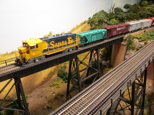 An ariel view of a 1970's era Santa Fe local freight train crossing the tall steel trestle. by Eddie from Chicago