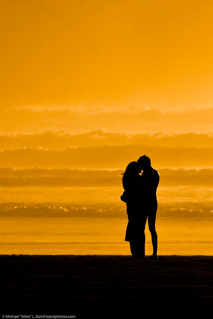 Lovers embracing on the beach at sundown / sunset on Morro Strand State Beach 10 Jan 2010