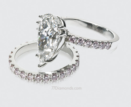 ring with 12 pink coloured diamonds and a matching platinum wedding band 