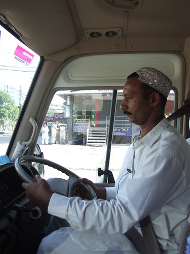Mohamed Khan drives us throughout the city. He wears an embroidered handcrafted hat