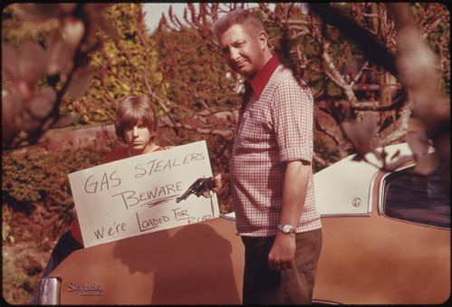 Country's Fuel Shortage Led to Problems for Motorists in Finding Gas as Well as Paying Much More for It, and Resulted in Theft From Cars Left Unprotected. This Father and Son, Made a Sign Warning Thieves of the Possible Consequences 04/1974