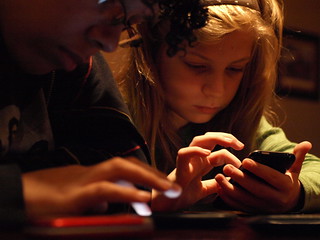 Children playing games on iPhones.