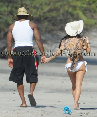 Reggie Bush and Kim Kardashian walk the beach on vacation at the Four 