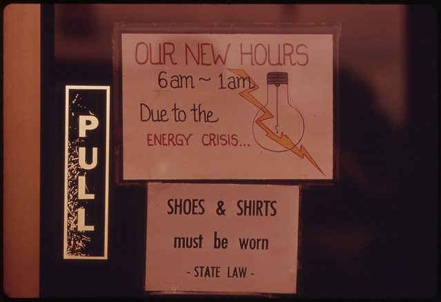 Sign Posted in a Doorway Entrance to a Restaurant Explaining Shorter Hours Due to the Fall of 1973 Energy Crisis in Oregon. The Business Was Located Along Interstate #5 10/1973