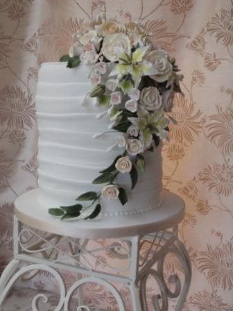 Grecian style wedding cake triple stacked cake wrapped in white icing 