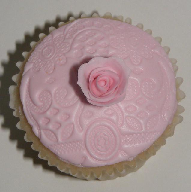 Sample wedding cupcakes with lace embossed fondant top and single rose