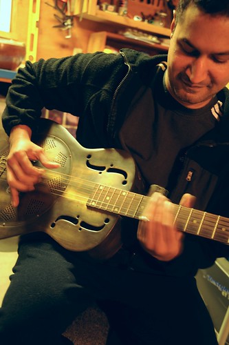 Abi playing his Dean Heirloom Resonator dobro guitar with a slide, garage, Tacoma, Washington, USA by Wonderlane