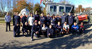 Coast Guardsmen from Coast Guard Station Tawas, in East Tawas, Mich., and members of the Coast Guard Sector Detroit Chief's Mess pose for a post run photo with Station Tawas' 25-foot response boat on Oct. 25, 2013.  Station Tawas crew members and the Sector Detroit Chief's Mess have fun a cumulative 1,000+ miles to earn canned food donations that they will distribute to those in need around the community.  U.S. Coast Guard photo by Seaman Daniel Frenger