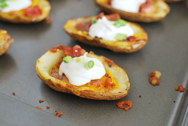 Potato Skins recipe! A classic! Filled with cheddar cheese, bacon, sour cream, and green onions! These are always a hit at football parties!