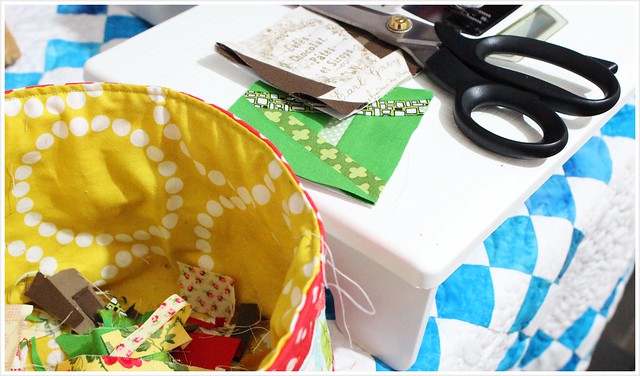 Using scissor to cut away excess in paper foundation and scrap basket keep clean