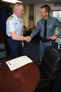 Courtesy Photo Coast Guard, NYS Park Police sign cooperative agreement Capt. Brian Roche, commander of Coast Guard Sector Buffalo, and Maj. David Page, commanding officer of the New York State Park Police Western Region, shake hands after signing a cooperative agreement between the NYS Park Police and the Coast Guard, Nov. 1, 2013. This historic cooperative agreement spells out the roles each agency will play during future operations between Niagara Falls and the whirlpool in the Niagara River gorge. (U.S. Coast Guard photo by Petty Officer 3rd Class Rory Boyle)  