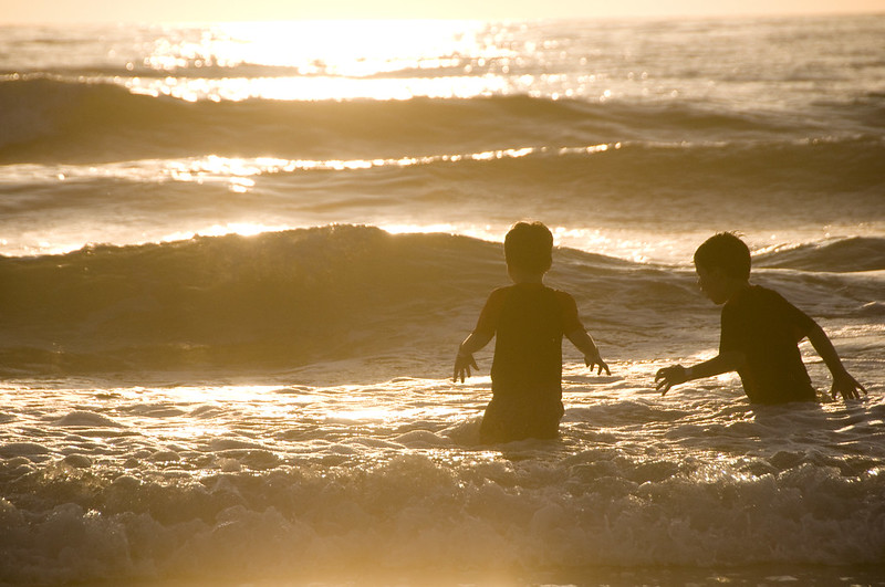 children in the surf