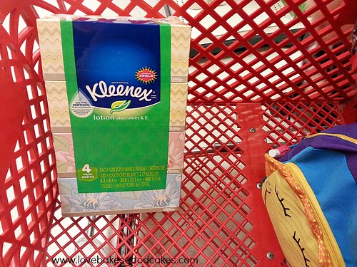 Kleenex 4 pack in shopping cart.