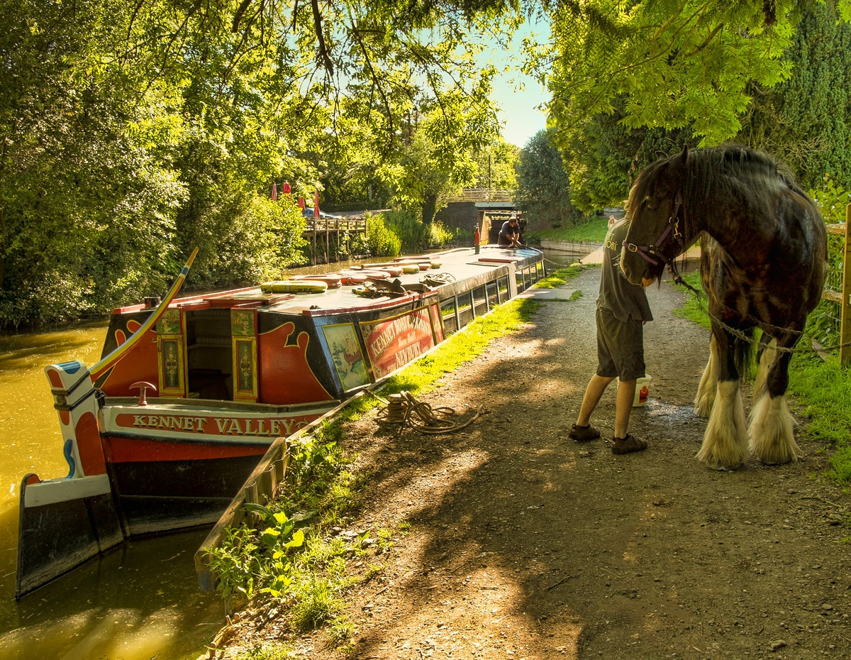 A horse drawn narrowboat on the Kennet and Avon canal at Kintbury in Wiltshire. Credit Anguskirk, flickr