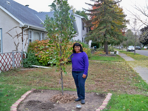 Frogtown homeowner Renee Taylor stands proudly next to her newly planted tree thanks to the tree planting partnership. (U.S. Forest Service/Teri Heyer)