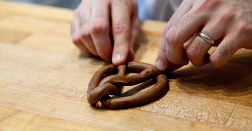 Shaping chocolate brioche into a pretzel