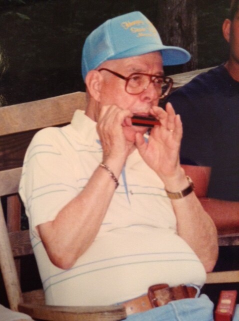 Grandpa playing his harmonica in 2002. His beautiful melodies echoed from the porch of his cabin to all those surrounding it.