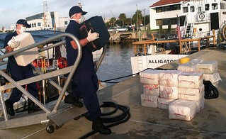 Coast Guard crewmembers offload 24 bales of cocaine at Coast Guard Sector St. Petersburg, Fla., Wednesday, Dec. 4, 2013. The crew of the Coast Guard Cutter Gallatin, a 378-foot high endurance cutter homported in Charleston, S.C., and their deployed MH-65 Dolphin Helicopter crew seized more than $18 million in cocaine in the Gulf of Mexico during two separate cases in November in support of Operation Martillo. U.S. Coast Guard photo by Petty Officer 2nd Class Michael De Nyse