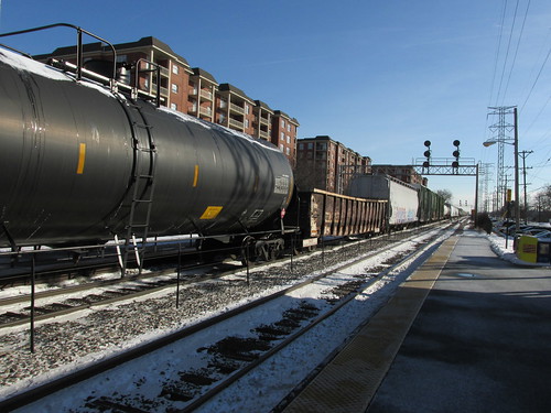 A northbound Norfolk Southern Railroad freight train passing through the Morton Grove Metra commuter rail station.  Morton Grove Illinois.  Thursday, December 12th, 2013. by Eddie from Chicago