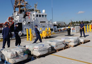Crewmembers aboard the Coast Guard Cutter Sitkinak, homeported in Miami Beach, Fla., offload 2,500 pounds of cocaine worth an estimated $37 million wholesale value, Tuesday January 28, 2014 at Coast Guard Base Miami Beach. The contraband was seized in a multi-national counterdrug operation south of the Dominican Republic and is the first time an armed U.S. Coast Guard helicopter embarked on a foreign flagged military vessel in support of counterdrug operations. U.S. Coast Guard photo by Petty Officer 1st Class Crystalynn A. Kneen. 