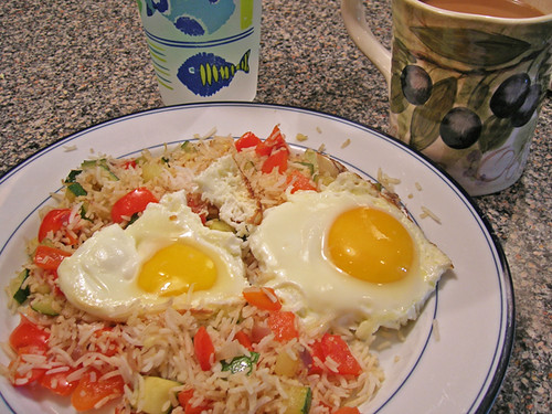 fried eggs with fried zucchini and red bell rice, water, coffee