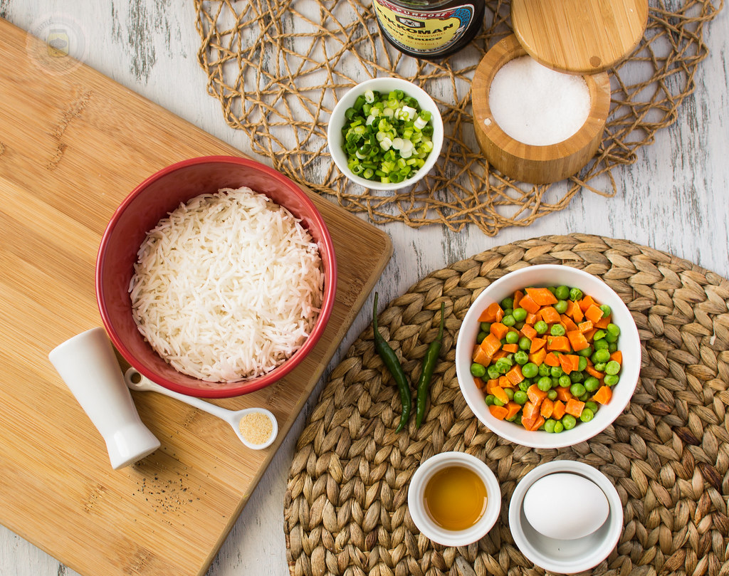 Ingredients shot: Vegetables in bowl, rice in a bowl, egg, salt and green onions