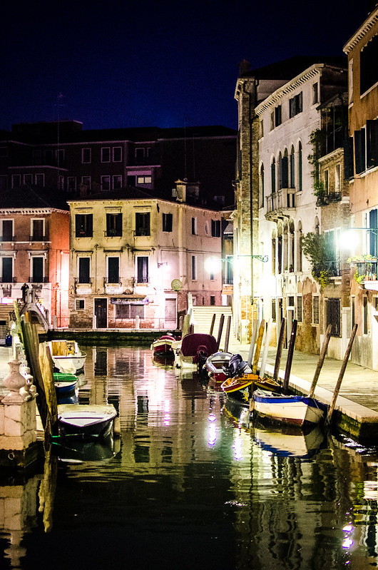 A quiet canal at night in Venice.