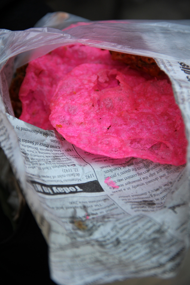 Pink puris wrapped in newspaper