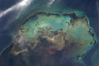 Sea, sand and clouds imitate a star forming nebula in the Caribbean
