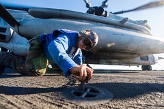 Sailor attaches chain to pad eye aboard USS Germantown.