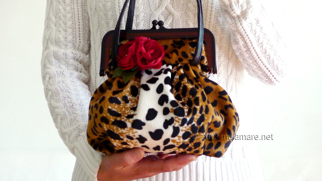 velvet handbag with leopard pattern handles
