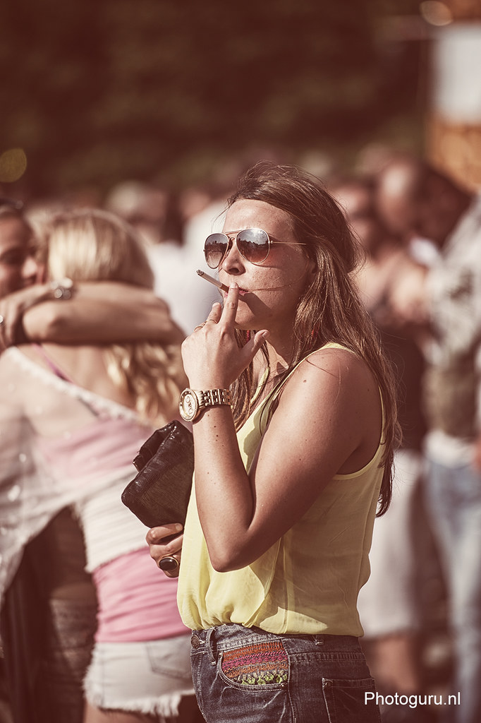 girl smoking cigarette during the festival