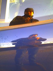 the high art of self portraiture in the window of a parking car