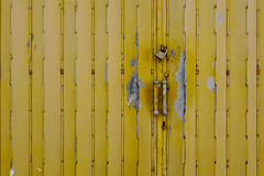 Yellow old steel door with lock