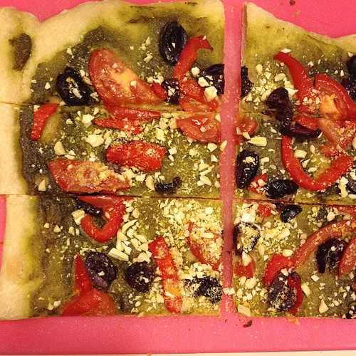 Dinner: homemade pizza! Pesto, kalamata's roasted red peppers, tomatoes and cashew parmesan.. #vegan