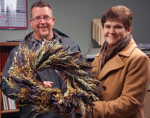 Ralph Cramer shows Deputy Harden some of the wreaths created with dried flowers from Cramer’s Posie Patch.