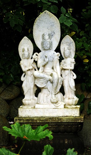 Three Bodhisattvas, Taras, posture of royal ease, tall auras or halos, tall headdresses, robes, standing on lotus, holding lotus flowers, white carved marble, on a lotus base, garden statue, private collection, Llandover by the Sound, Seattle, Washington by Wonderlane
