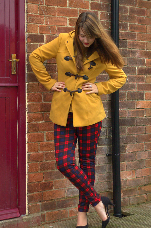 Mustard coat, mustard jumper, tartan trousers, heels