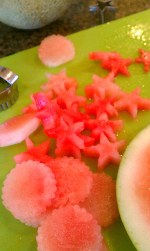 cutting stars out of watermelon for watermelon birthday cake