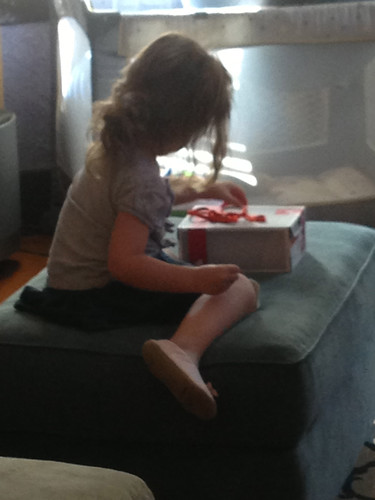 Trying so hard to tie her shoe box