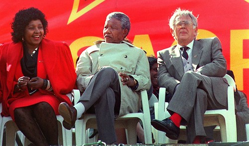 Winnie Mandela with Nelson Mandela and Joe Slovo at a rally of the South African Communist Party in 1990. Mandela was a member of the Central Executive Committee of the SACP. by Pan-African News Wire File Photos