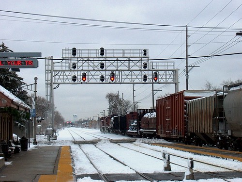 Eastbound Canadian Pacific freight train passing through the River Grove Illinois Metra commuter rail station.  December 1st, 2006. by Eddie from Chicago