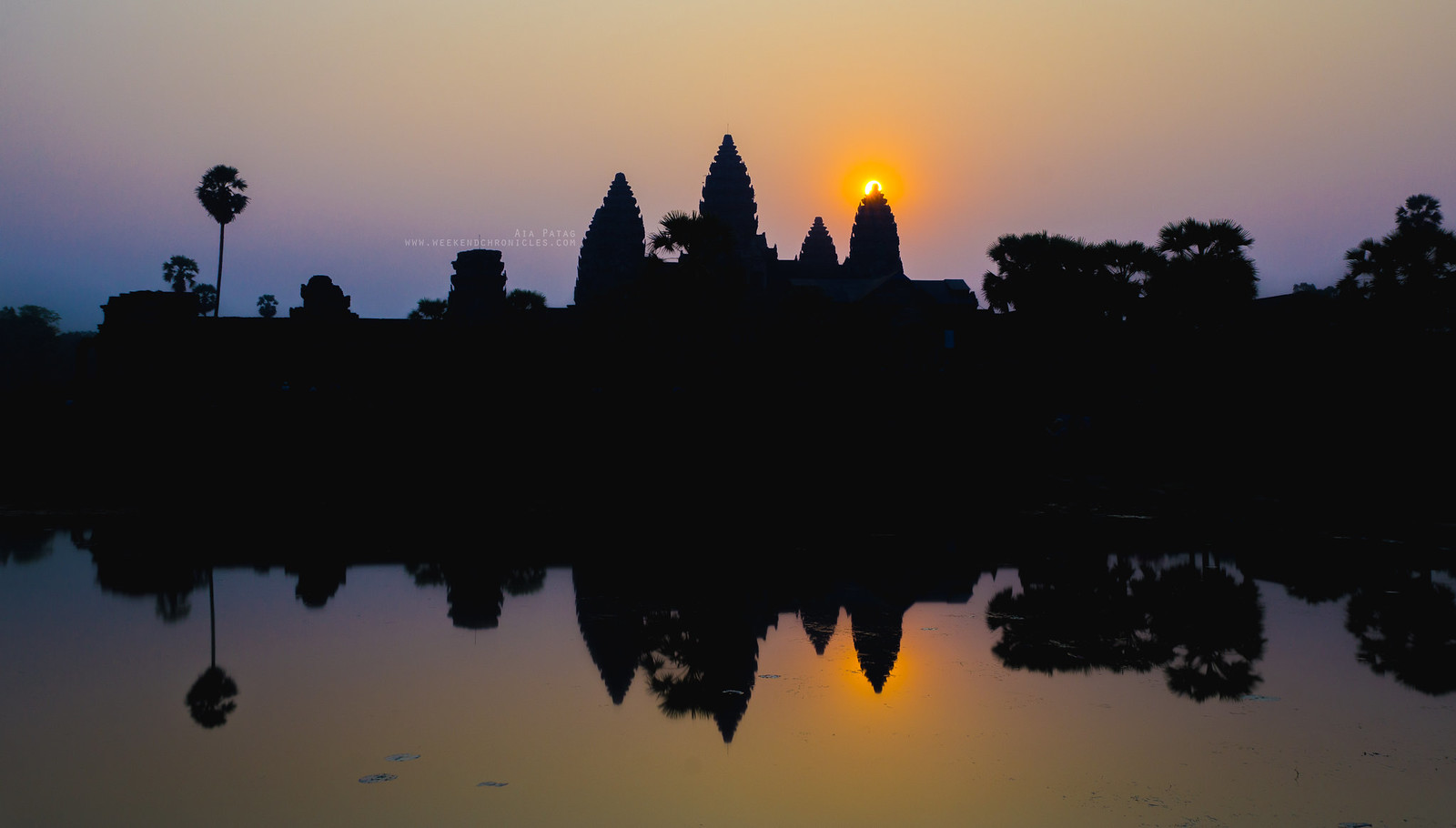 The sun rising behind Angkor Wat