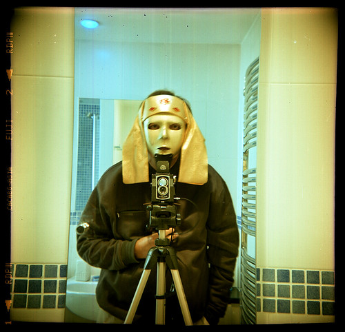 reflected self-portrait with Ross Ensign Ful-Vue camera and Egyptian headress by pho-Tony