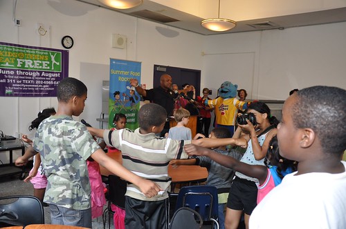 Former Washington Redskins running back Brian Mitchell leads the kids through exercises after talking about how important good nutrition was to his longevity in the NFL. 