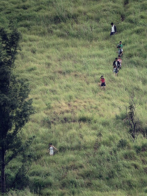 Hikers trailing down the steep side of mountain. Photographed by Bernard Eirrol Tugade