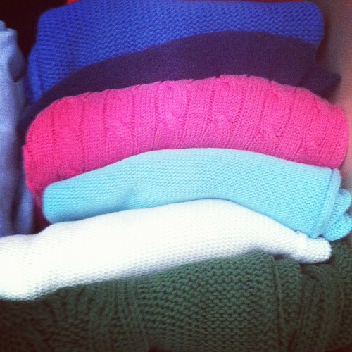 #folded knit pullovers on my closet shelf.