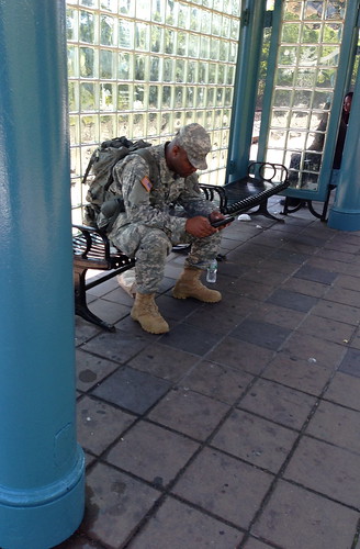 A soldier, waiting for the light rail